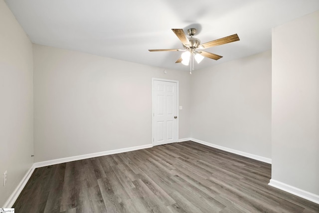 empty room featuring ceiling fan and dark hardwood / wood-style floors