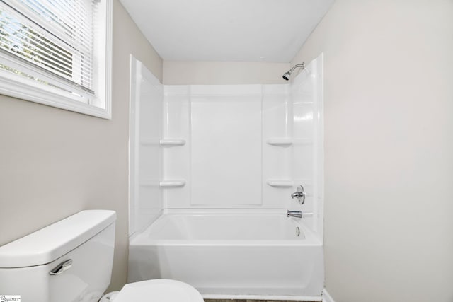 bathroom featuring shower / bathtub combination and toilet