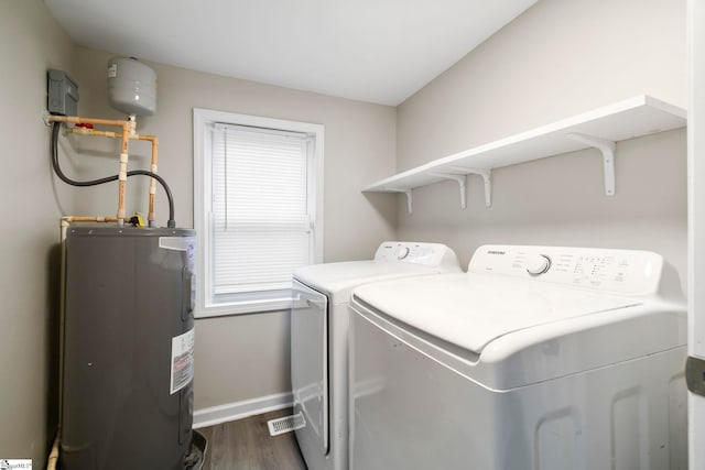 laundry room featuring dark hardwood / wood-style flooring, independent washer and dryer, and water heater