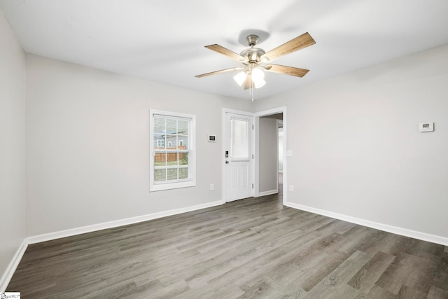 empty room with hardwood / wood-style floors and ceiling fan