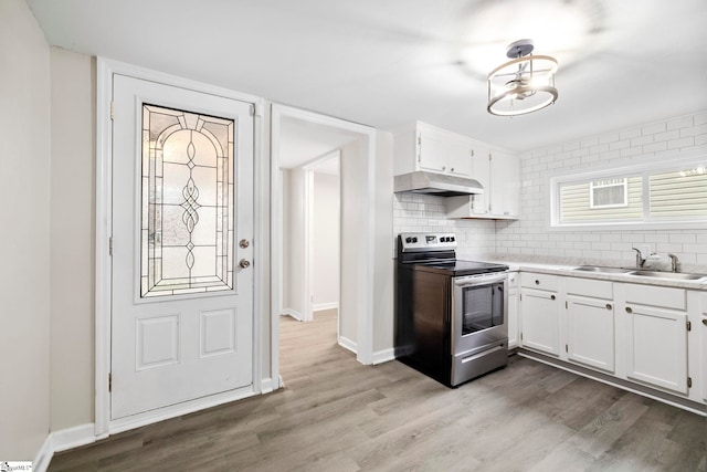 kitchen featuring white cabinets, sink, electric range, and light wood-type flooring