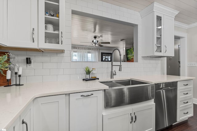 kitchen featuring white cabinetry, light stone countertops, sink, backsplash, and stainless steel dishwasher