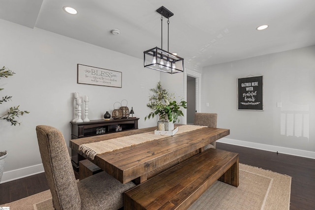 dining space with a chandelier and dark hardwood / wood-style floors