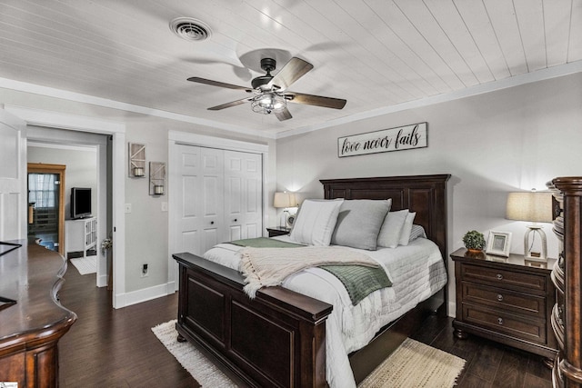 bedroom featuring a closet, ceiling fan, dark hardwood / wood-style flooring, wooden ceiling, and ornamental molding