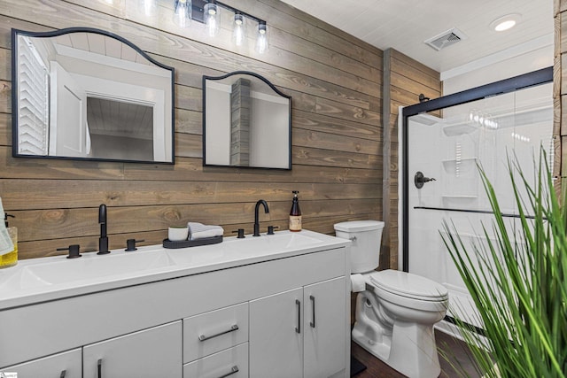 bathroom featuring wood walls, vanity, an enclosed shower, and toilet