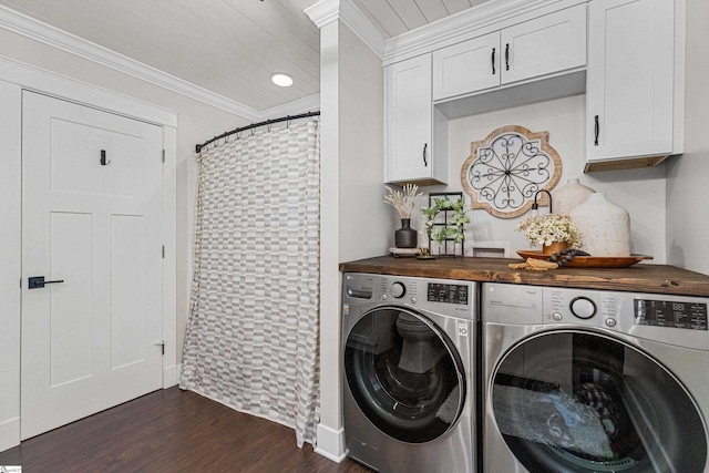 laundry area featuring cabinets, independent washer and dryer, dark hardwood / wood-style flooring, and ornamental molding