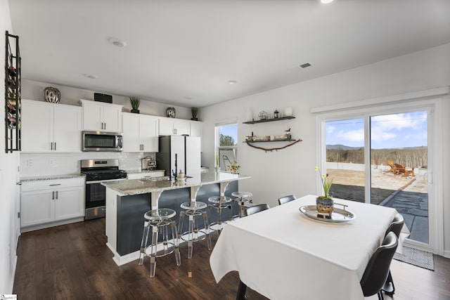 dining room with sink and dark wood-type flooring