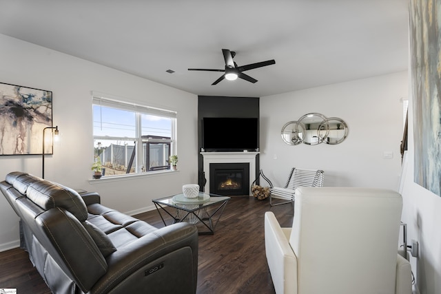 living room with radiator, ceiling fan, and dark wood-type flooring