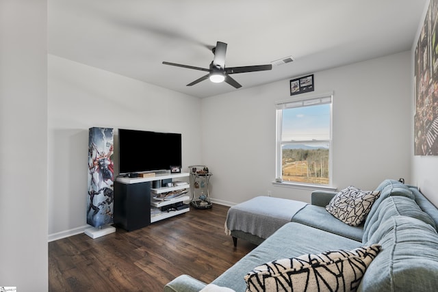 living room featuring ceiling fan and dark wood-type flooring