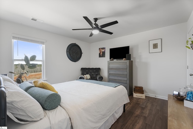 bedroom with ceiling fan and dark hardwood / wood-style flooring