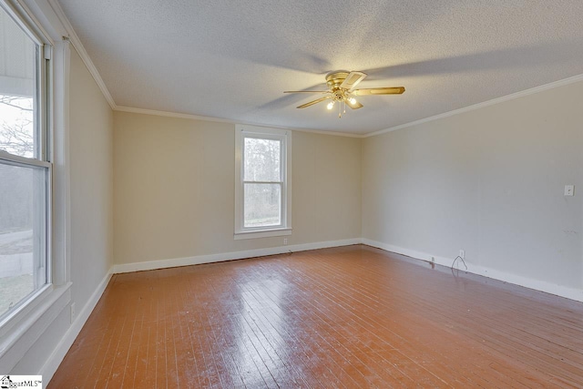 spare room featuring hardwood / wood-style floors, ceiling fan, a textured ceiling, and crown molding