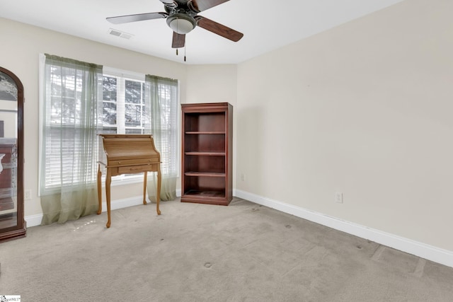 interior space featuring plenty of natural light, light carpet, and ceiling fan