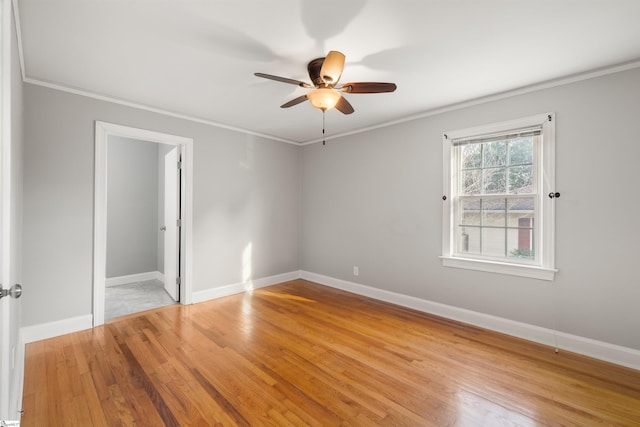 unfurnished room featuring baseboards, ceiling fan, light wood-style flooring, and crown molding