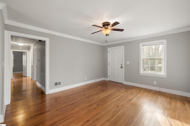 spare room with visible vents, baseboards, and wood finished floors