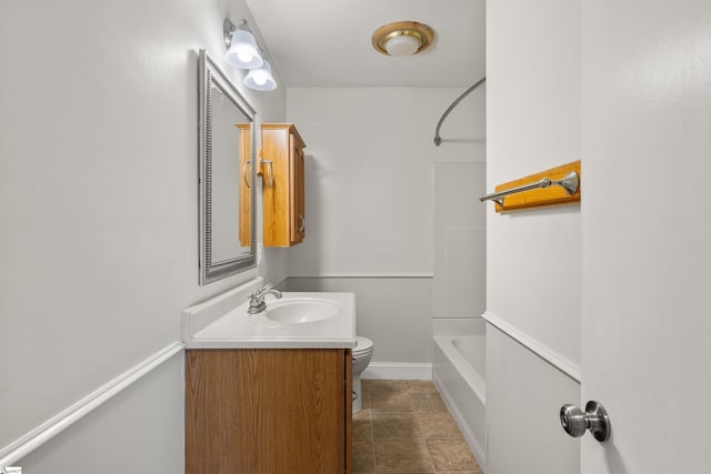 full bathroom featuring baseboards, vanity, toilet, and shower / tub combination