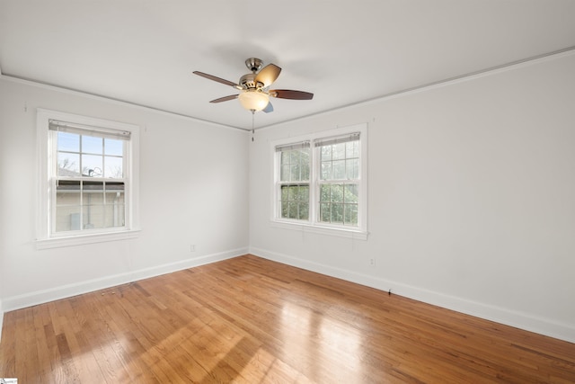 unfurnished room with baseboards, a ceiling fan, light wood-style floors, and a healthy amount of sunlight