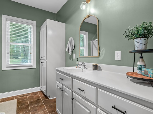 full bathroom featuring visible vents, vanity, and baseboards