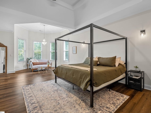 bedroom with baseboards, dark wood-type flooring, a chandelier, and crown molding