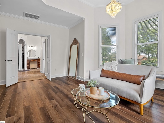 living area featuring visible vents, arched walkways, crown molding, dark wood finished floors, and a notable chandelier