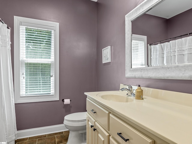 full bathroom featuring tile patterned floors, baseboards, plenty of natural light, and vanity