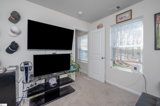 living room with carpet flooring, baseboards, and visible vents