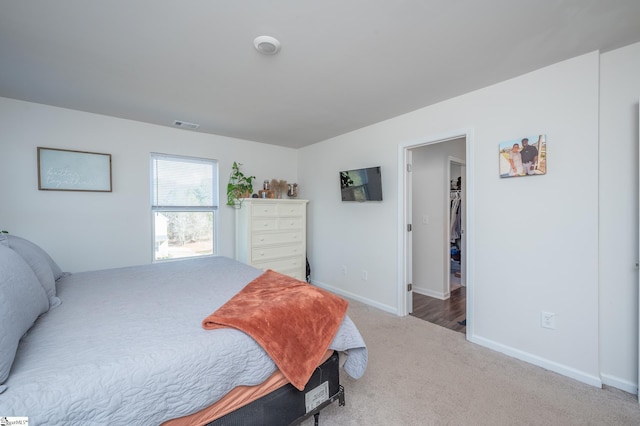 carpeted bedroom with baseboards and visible vents