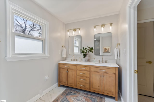 bathroom featuring marble finish floor, plenty of natural light, and a sink