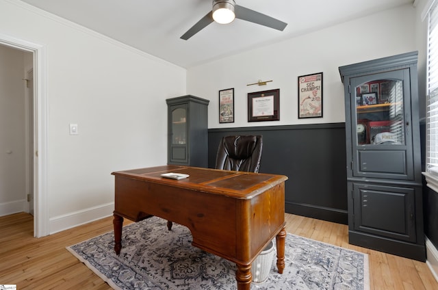 home office featuring light wood finished floors, ceiling fan, and baseboards