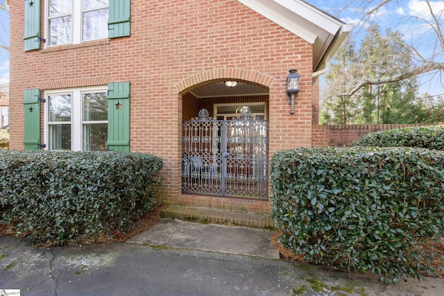 doorway to property featuring brick siding