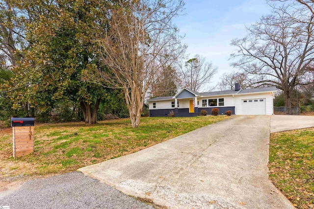 ranch-style house featuring an attached garage, a chimney, a front lawn, and concrete driveway