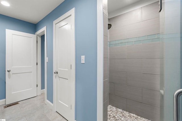 bathroom featuring a shower stall, visible vents, and baseboards