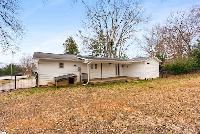 back of property featuring fence and a wooden deck