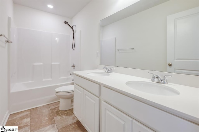 bathroom featuring double vanity, shower / washtub combination, a sink, and toilet