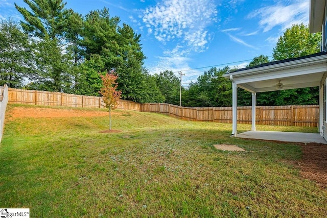 view of yard with a fenced backyard, a patio, and ceiling fan