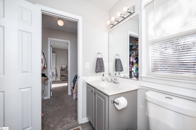 bathroom featuring vanity and toilet