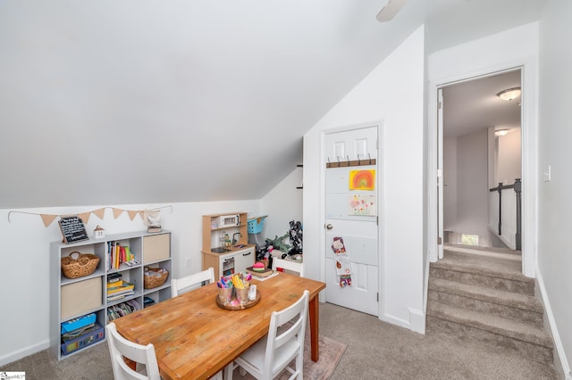 rec room featuring light carpet, lofted ceiling, and baseboards