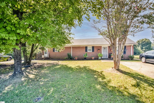 single story home featuring a front lawn and brick siding