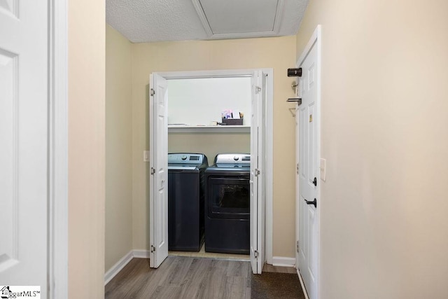 laundry area featuring light wood-type flooring, laundry area, baseboards, and separate washer and dryer