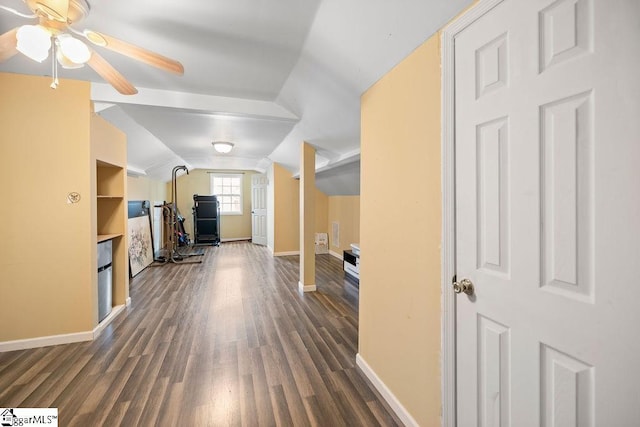 living area featuring lofted ceiling, dark wood-style flooring, a ceiling fan, and baseboards