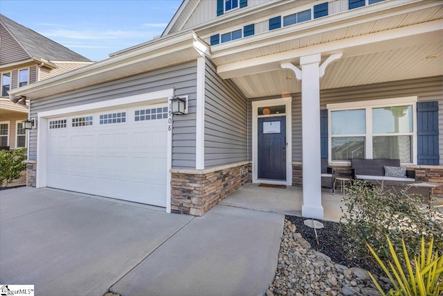 doorway to property with stone siding, a porch, and board and batten siding