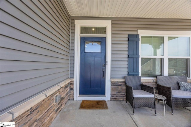 property entrance with stone siding