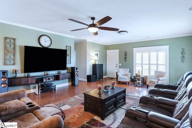 living room featuring baseboards, ceiling fan, ornamental molding, and wood finished floors