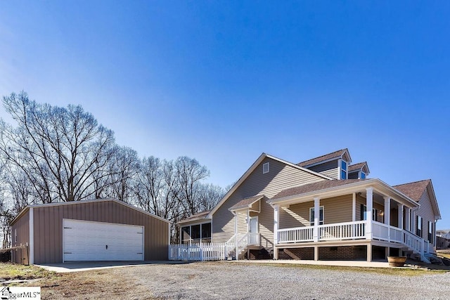 view of front facade with a garage, fence, and a porch