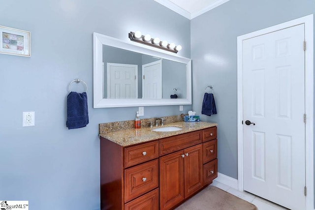 bathroom with tile patterned floors, crown molding, and vanity