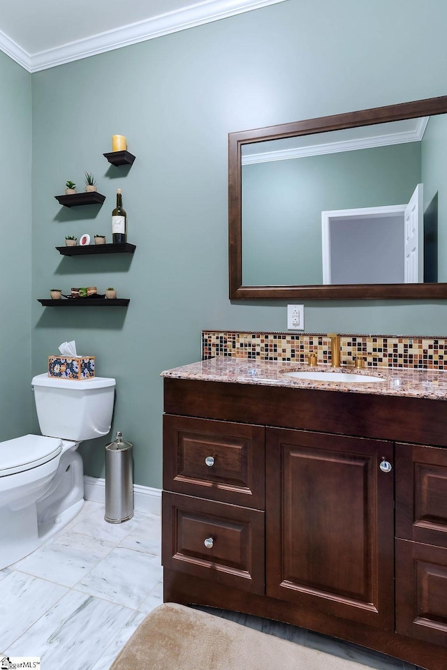 half bathroom featuring baseboards, toilet, ornamental molding, marble finish floor, and vanity