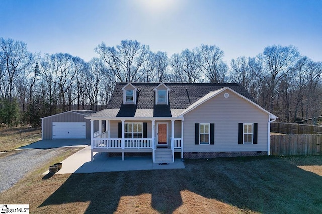 view of front of home with an outbuilding, roof with shingles, a porch, a front yard, and fence