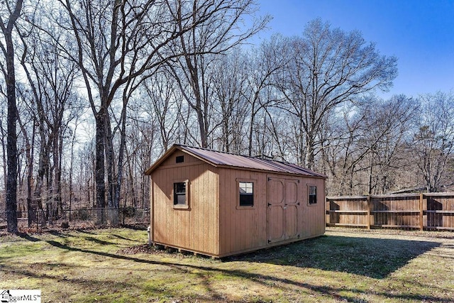 view of shed with a fenced backyard