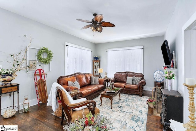 living room featuring ceiling fan, dark wood-type flooring, and baseboards