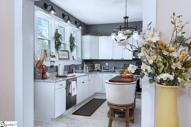 kitchen with a sink, white cabinetry, hanging light fixtures, dishwasher, and dark stone countertops