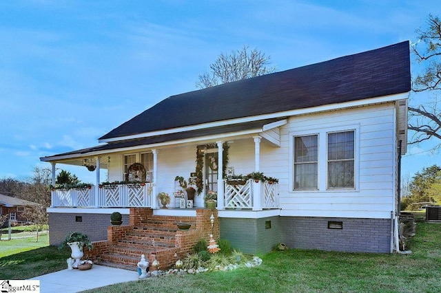 view of front of house with a porch, crawl space, and a front yard